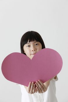 chinese girl holding a blank heart shape cardboard