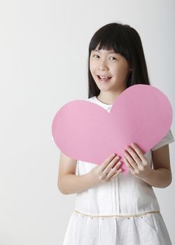 chinese girl holding a blank heart shape cardboard