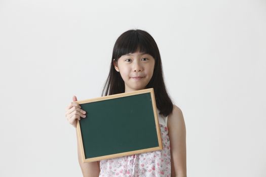 chinese girl holding a small chalk board