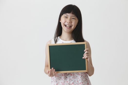 chinese girl holding a small chalk board