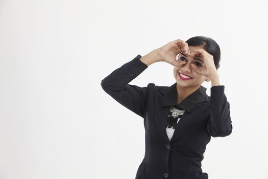 young woman looking through imaginary binocular