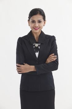 Portrait of a well-dressed young business woman with cross-armed

