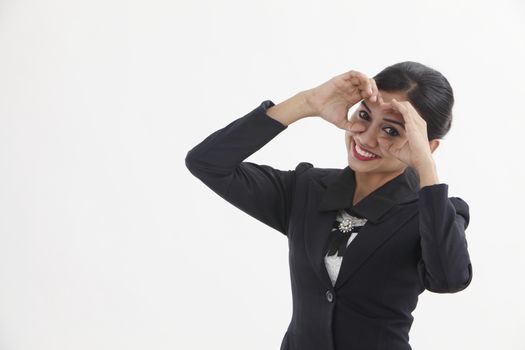 young woman looking through imaginary binocular