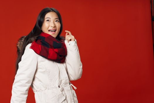 Woman in white winter jacket scarf cool studio Red isolated background lifestyle