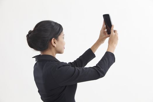 Side view business woman self portrait with smart phone