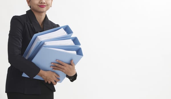 mid section on businesswoman carrying a stack of file