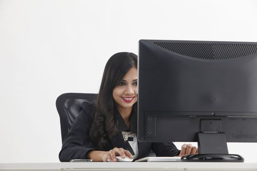 business woman sitting in front monitor working