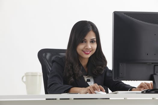 business woman sitting in front monitor working