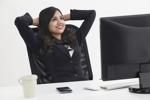 business woman sitting in front monitor taking a break