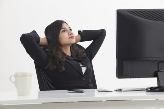 business woman sitting in front monitor taking a break