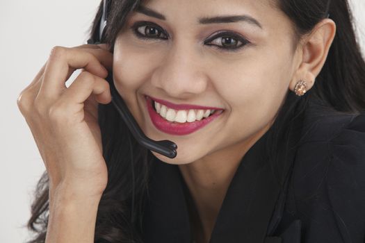 Side view of beautiful receptionist wearing head set talking