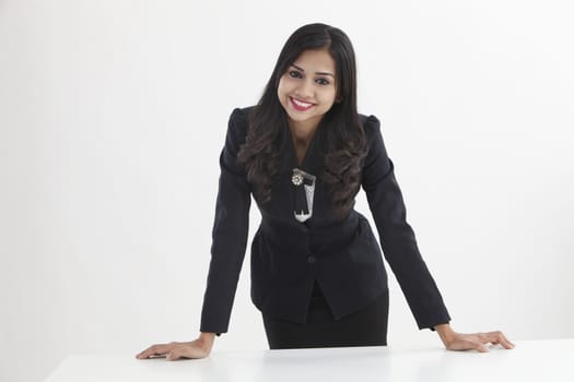 businesswoman standing behind of the desk confident