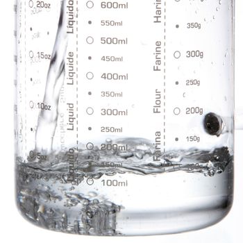 pouring water in to measuring jar