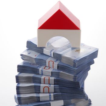 modal house on top of money stacked high