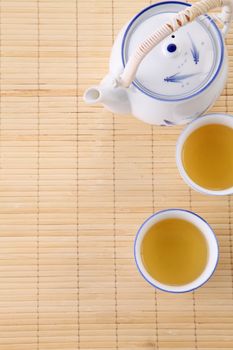 Japanese white tea pot on the bamboo mat