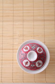 Japanese white tea pot on the bamboo mat