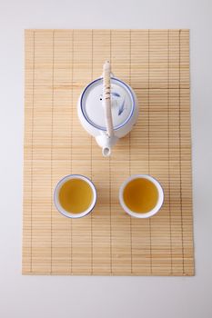 Japanese white tea pot on the bamboo mat