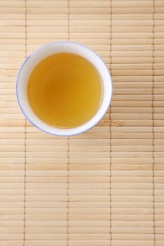 Japanese white tea pot on the bamboo mat