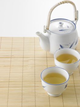 Japanese white tea pot on the bamboo mat