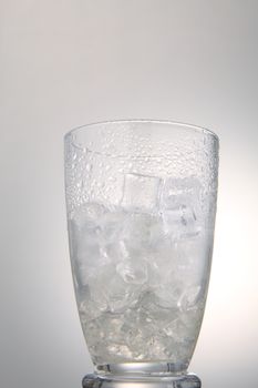 photo of empty glass with ice cubes on white background