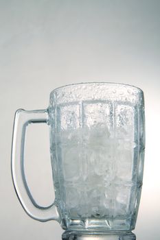 photo of empty glass with ice cubes on white background