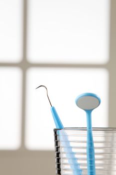 Dentist tools in glass table close up