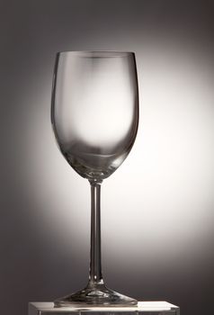 Empty wine glass on the gray background