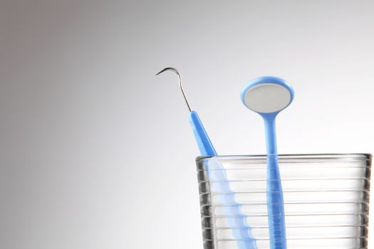 Dentist tools in glass table close up