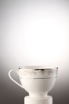 Flowered antique tea cup isolated on a white background 