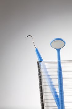 Dentist tools in glass table close up