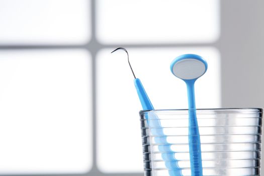 Dentist tools in glass table close up