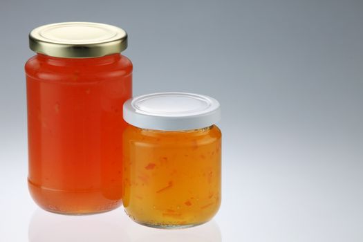 tangerine and pineapple fruit jam in the glass container