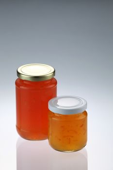 tangerine and pineapple fruit jam in the glass container