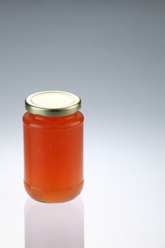 tangerine or citrus fruit jam in the glass container