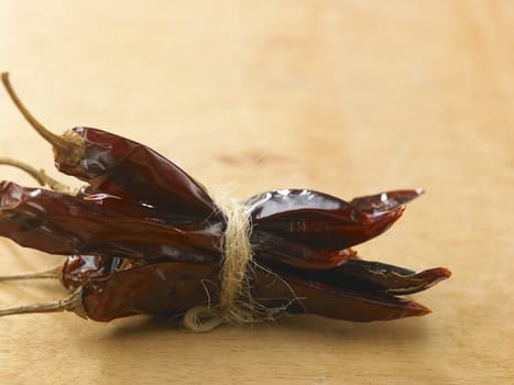 Bunch of dried chili on wooden table top