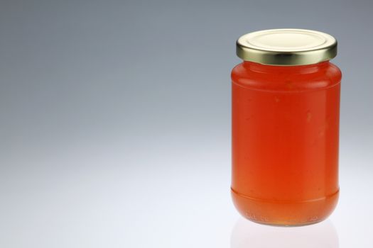 tangerine or citrus fruit jam in the glass container