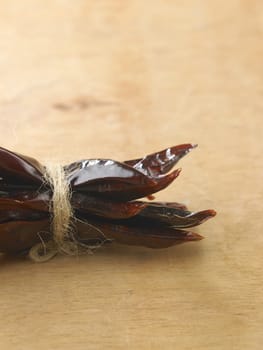 Bunch of dried chili on wooden table top