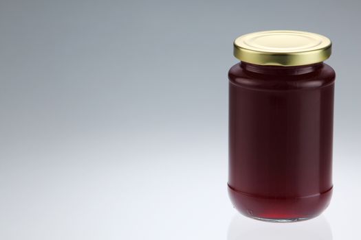 cranberry fruit jam in the glass container