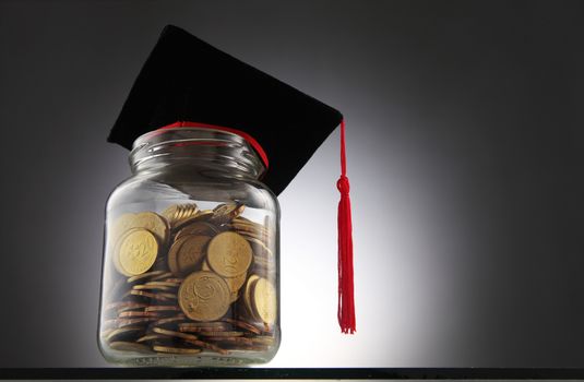 Bottle of cash with graduation cap.