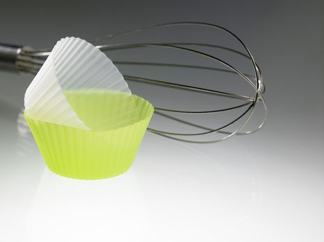 whisk and the silicone muffin holder