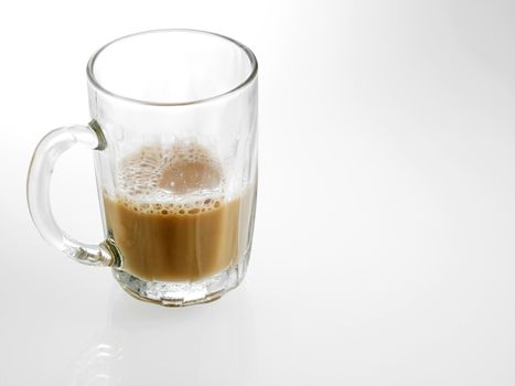 Half glass of Tea with milk or Teh Tarik in Malaysia