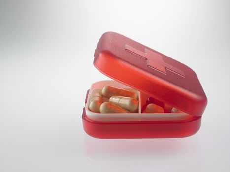 red pill box with medicine