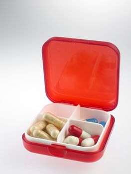 red pill box with medicine