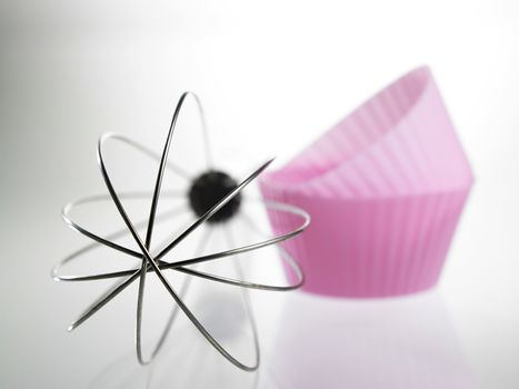 whisk and the silicone muffin holder