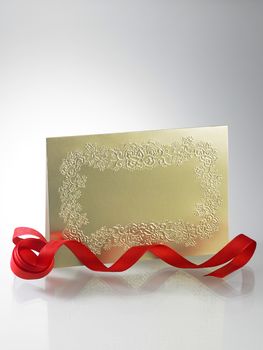 golden invitation card with ribbon