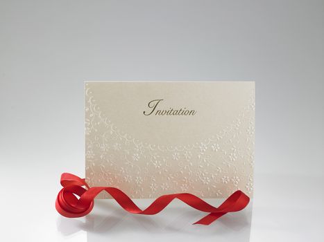 golden invitation card with ribbon