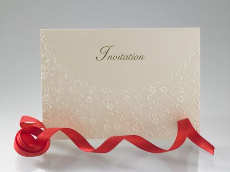 invitation card with red ribbon
