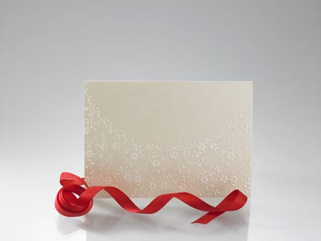 blank greeting card with red ribbon