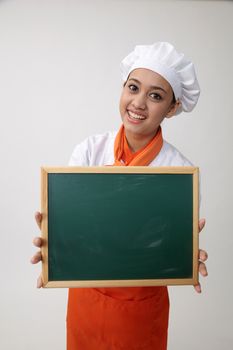 Portrait of a Indian woman with chef uniform holding chalk board