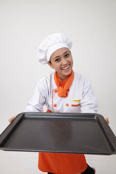 Portrait of a Indian woman with chef uniform holding an empty tray